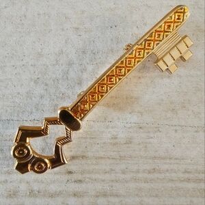 Goldtone art deco style skeleton key brooch w/ amber color enamel